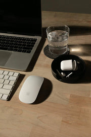 Graf Lantz - Kobon Leather Round Tray - Black, elegantly displayed on a desk with a laptop and mouse, ideal for organizing office essentials.