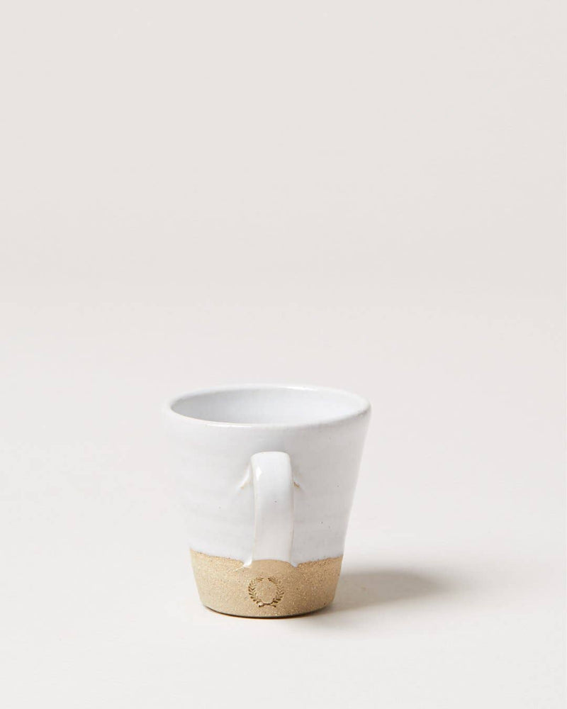 Farmhouse Pottery - Silo Espresso Cup: Single, handmade ceramic mug with white glaze and natural stoneware base, featuring a stamped wreath emblem, perfect for espresso shots.