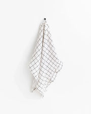 MagicLinen ruffle trim tea towel hanging on a hook, showcasing its soft, durable linen texture, ideal for adding style and practicality to any kitchen.