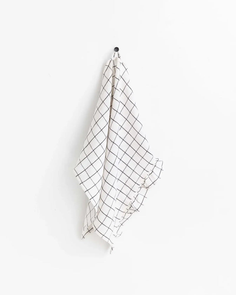 MagicLinen - Ruffle trim tea towel hanging on a hook, showcasing its durable, soft linen texture, ideal for stylish, practical kitchen use.
