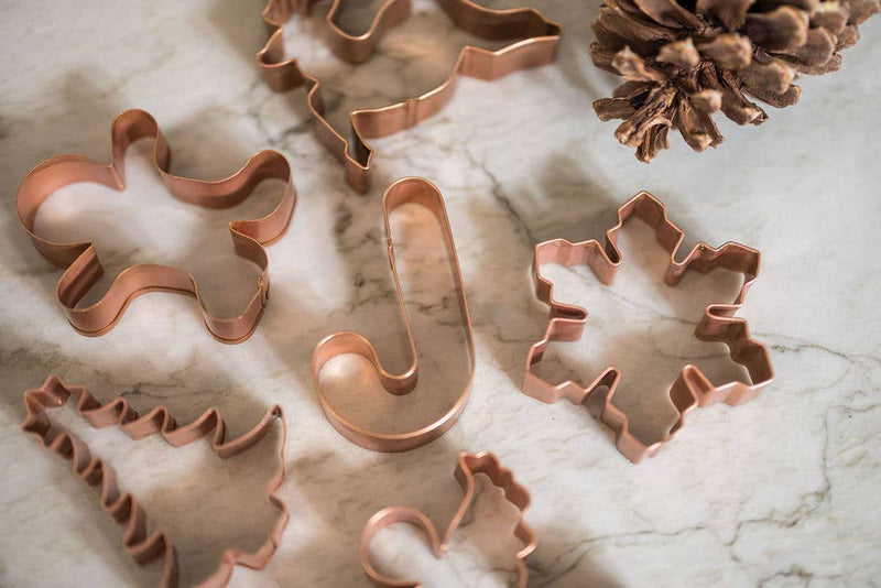 Galley and Fen - Christmas Cookie Cutters - Set of 6 on marble, featuring holiday shapes like gingerbread, snowflake, and reindeer, ideal for festive baking.
