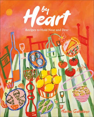 Cover of By Heart: Recipes to Hold Near and Dear cookbook featuring a vibrant dining table scene with lemons, tomatoes, wine, and appetizers.