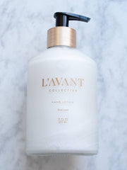 L'AVANT Collective - Fresh Linen Hand Lotion in a sleek white bottle with a black lid, featuring gold text, ideal for luxurious hand pampering.