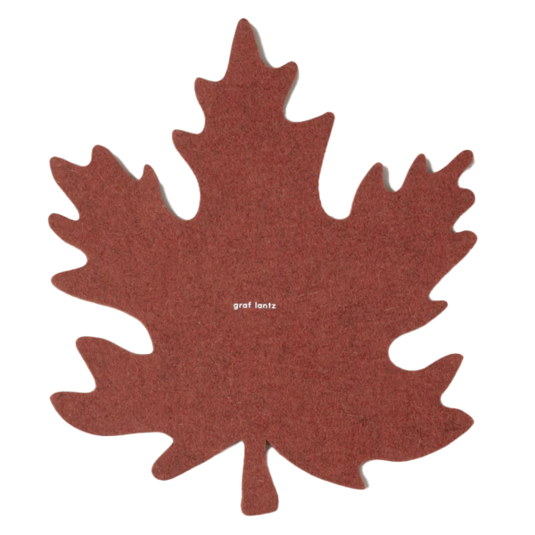 Graf Lantz Merino Wool Autumn Trivet in mahogany, showcasing a red felt leaf design with white text, ideal for enhancing culinary presentations and protecting surfaces.