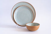 RachaelPots - Dinner Plate: Coral, featuring speckled pale-blue glaze with rustic brown rims, displayed with matching bowl. Hand-thrown stoneware, microwave and dishwasher safe.
