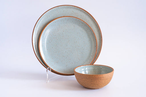 RachaelPots - Dinner Plate: Nude/Light Blue, featuring a speckled pale-blue interior and natural terracotta exterior, set with a matching bowl on a white background.