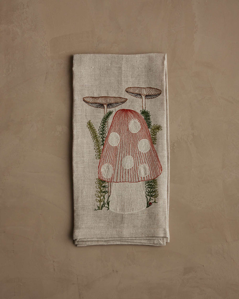 Coral & Tusk - Mushroom Tea Towel features embroidered mushrooms and ferns, adding whimsy to your kitchen decor. Perfect for culinary enthusiasts in Athens Cooks.