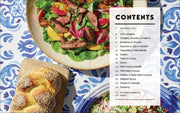 Penguin Random House LLC - Shabbat cookbook contents surrounded by a grilled steak salad, sesame challah, and grain salad, highlighting Jewish culinary traditions and weekly Shabbat meals.