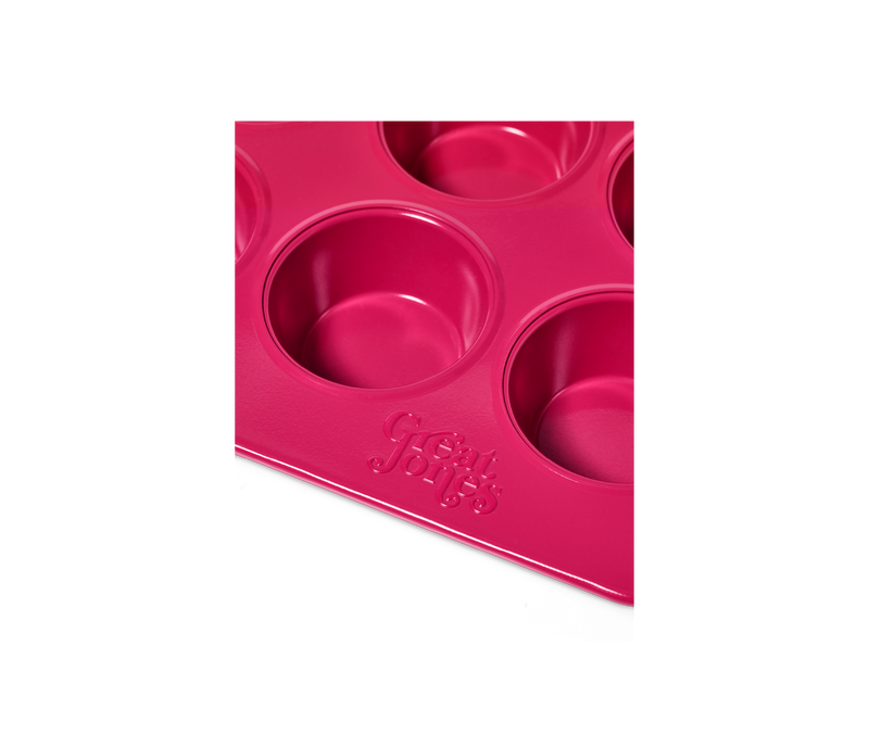 Close-up of Great Jones | Stud Muffin - Blueberry muffin pan, featuring nonstick, nontoxic surface for 12 muffins, with even heat distribution and easy cleanup.