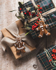 Farmhouse Pottery - Felted Gingerbread Ornament: Gentleman, handcrafted in Nepal, adorns a gift with plaid wrap, adding a cozy, handmade touch to holiday presents.