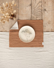 MagicLinen - Double Layer Linen Placemat Set of 2: Light grey, displayed beneath a floral-designed plate, enhancing table decor with its soft, stylish linen texture.