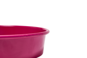 Great Jones | Patty Cake - Broccoli: A close-up of a pink mixing bowl showcasing its wavy, corrugated bottom, designed for easy release and scratch resistance.