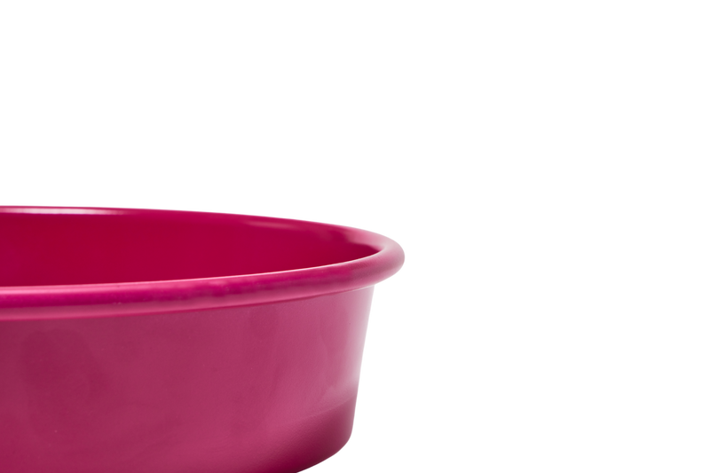 Great Jones | Patty Cake - Broccoli: A close-up of a pink mixing bowl showcasing its wavy, corrugated bottom, designed for easy release and scratch resistance.