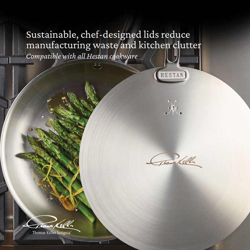 Hestan Provisions | Commercial Clad Stainless Steel Universal Lid, 8.5 Inches, covers a sauté pan with asparagus, featuring a Thomas Keller design for sustainable cooking.