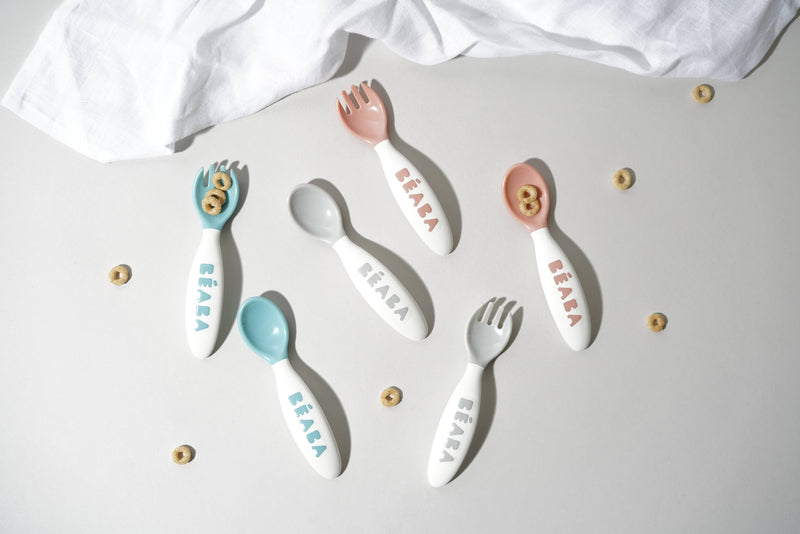 BEABA Toddler's Self-Feeding Cutlery - Breeze, featuring a close-up of a spoon and fork set, designed for safe, ergonomic self-feeding, displayed on a white surface.