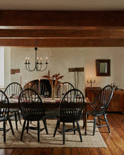 Coral & Tusk - Sunflower and Wheat Dinner Napkin adorns a rustic table set in a farmhouse dining room, enhancing the inviting, traditional charm with its embroidered details.