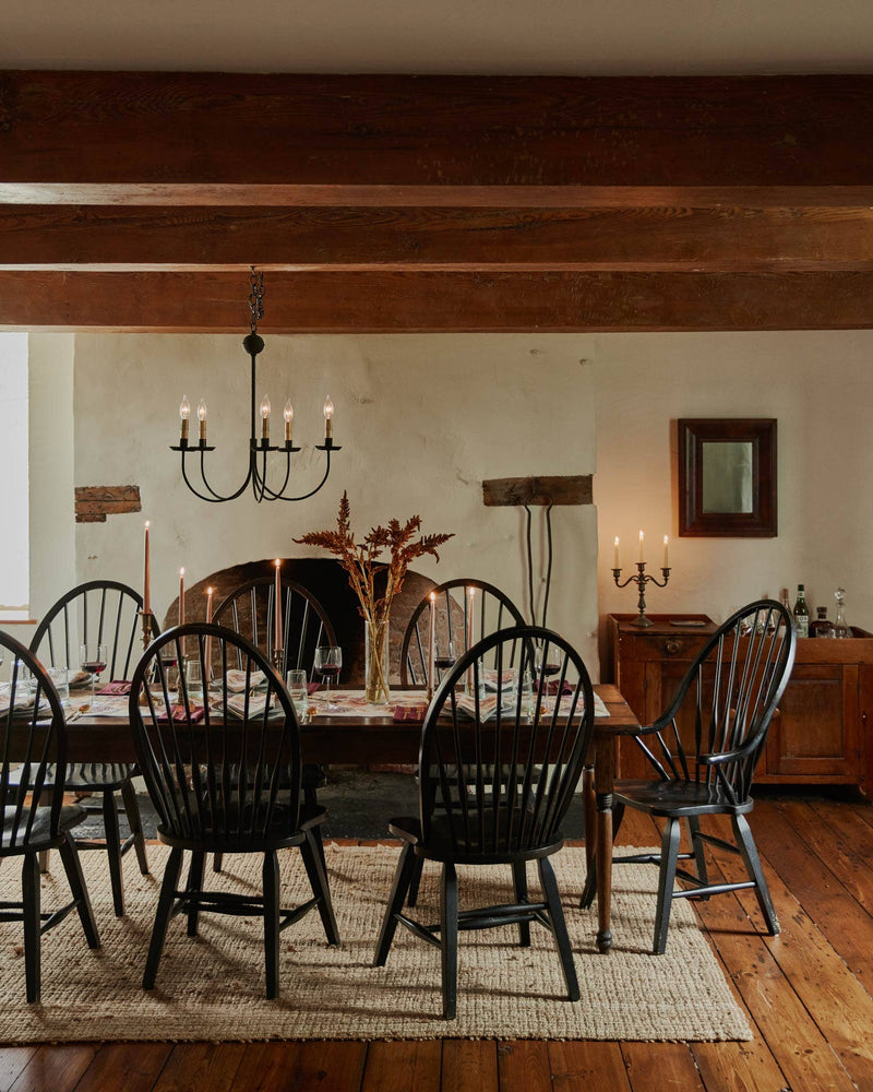 Coral & Tusk - Sunflower and Wheat Dinner Napkin adorns a rustic table set in a farmhouse dining room, enhancing the inviting, traditional charm with its embroidered details.