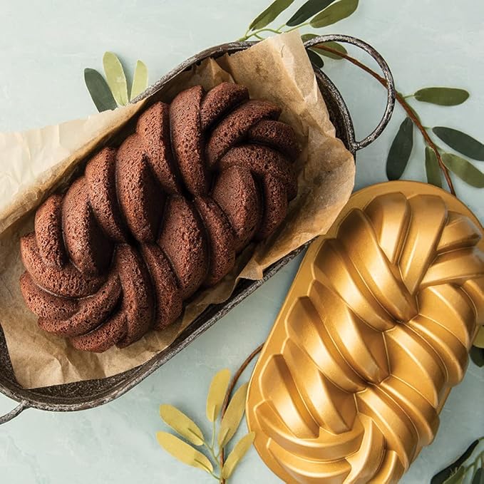 Nordic Ware | Braided Loaf Pan in metal, showcasing dual-strand design, perfect for detailed baking, seen alongside another loaf in a similar pan.