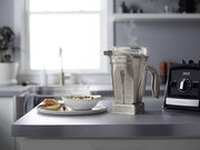 Vitamix | 48 oz Stainless Steel Container on a kitchen counter with a blender and a bowl of soup, ideal for professional-grade blending.