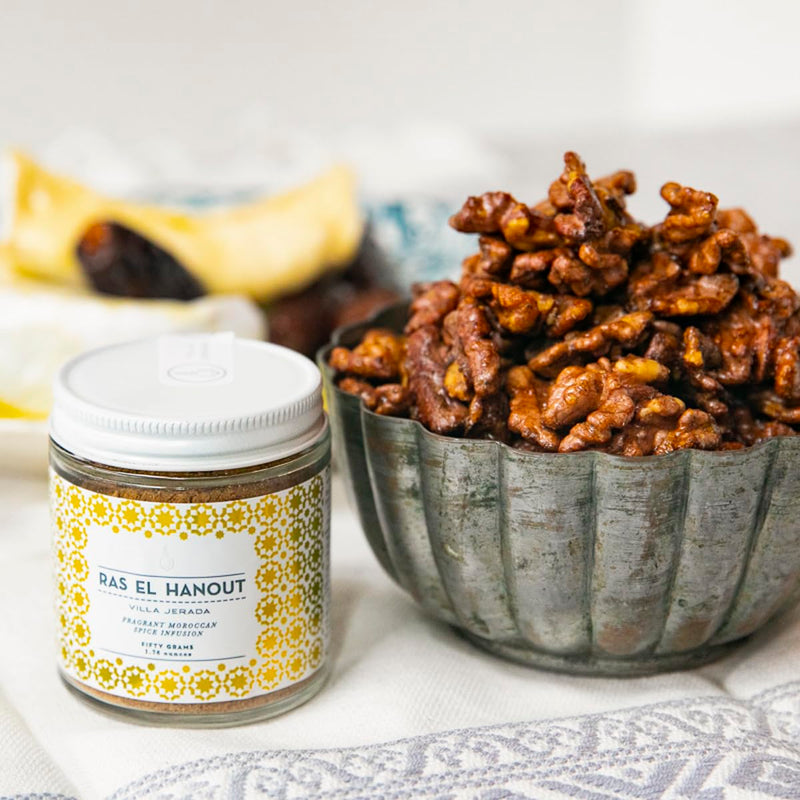 Villa Jerada Ras el Hanout spice blend with nuts and peanut butter jar, ideal for enhancing Moroccan dishes, seen on a kitchen countertop.