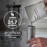 A person pours Aarke Enriched Filter Refill Granules into a metal container, showcasing its sleek design for Carbonator models.