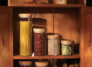 Browne & Co | BERARD Glass Jar with Lid, 4x4.25, visible on a wooden shelf among various preserved foods in mason jars, ideal for kitchen storage.