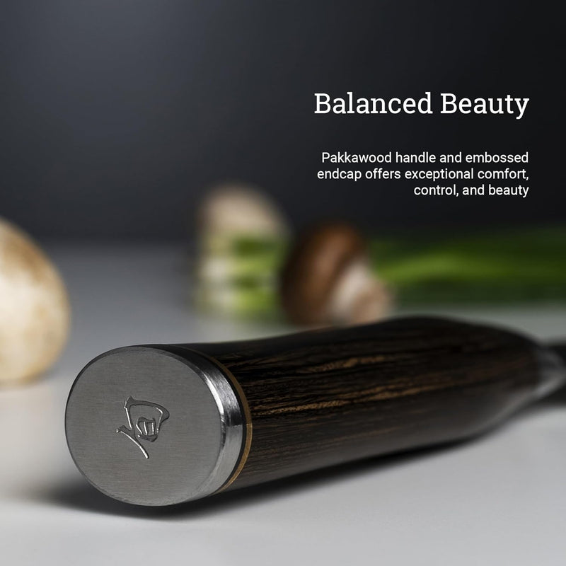 Close-up of Shun | Premier Starter Set, Walnut, 3-Piece knife handle with embossed metal endcap, highlighting its Pakkawood design, ideal for culinary tasks.