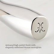 Hestan | Stainless Steel Whisk 13 Inches: Close-up of the polished handle end with embossed H monogram, showcasing its sleek design and ergonomic grip.