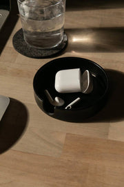 Graf Lantz - Kobon Leather Round Tray - Black, featuring white earbuds inside, elegantly displayed, ideal for organizing small items at home or office.