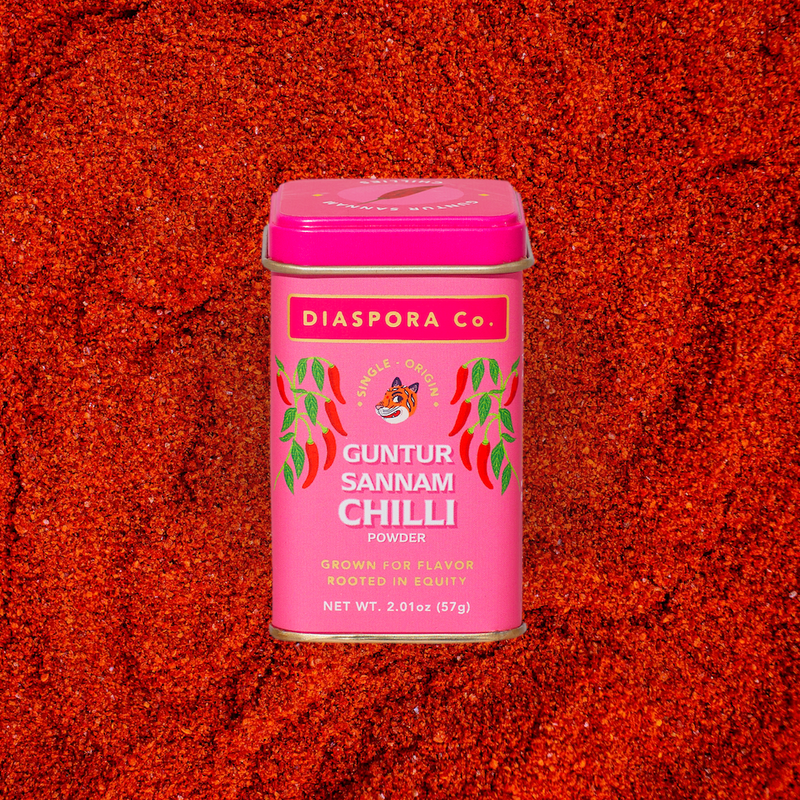 Diaspora Co. Spices - Guntur Sannam Chilli: Pink container with a lid featuring a tiger illustration and spice label, containing ground Sannam chillies.