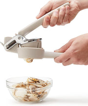 Chef'n FreshForce Handheld Slicer in use, slicing mushrooms effortlessly. A person demonstrates its ease and safety in a kitchen setting.