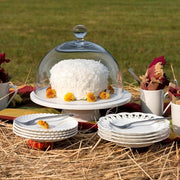 Fortessa | Arezzo 60 piece Place Setting displayed with a cake covered in a glass dome, emphasizing elegance and sophistication for a refined dining experience.