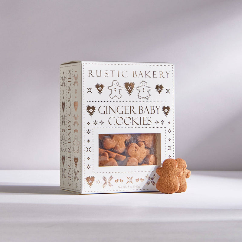 Rustic Bakery - Ginger Baby Cookies in a decorative box with two gingerbread-shaped cookies visible. Includes 12 boxes, perfect for festive indulgence.