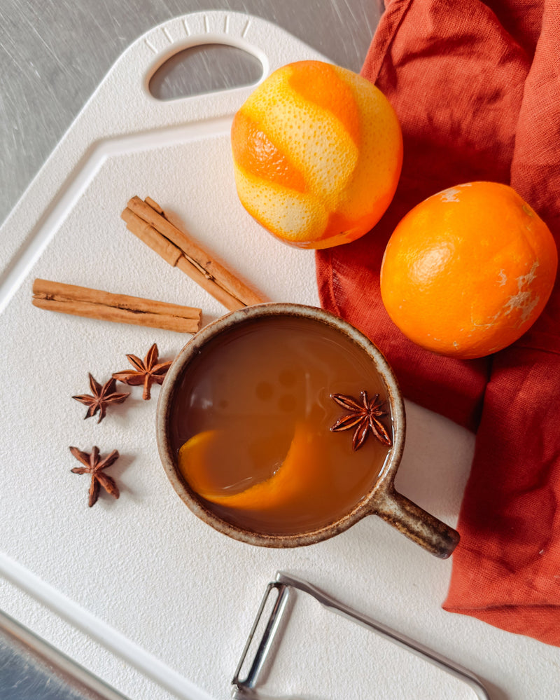 The MK Free Board™️ features a plant-based material, shown with spiced drink ingredients, emphasizing its eco-friendly and knife-friendly surface, ideal for safe kitchen use.