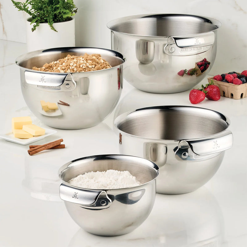 Stainless steel mixing bowl set by Hestan, featuring sizes 1.5qt, 3.0qt, 4.75qt, and 7.0qt, filled with various ingredients.