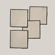 ATELIER SAUCIER - Cream Burlap Noir Cocktail Napkins | Set of 4: Abstract collage depicting elegant napkins with cream burlap and bold black edges, ideal for sophisticated entertaining.