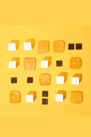 Malvi Mallow - Honey Vanilla 4-Pack Marshmallows, Case of 12 Packs, arranged in a neat grid with chocolate and caramel squares on a yellow background.