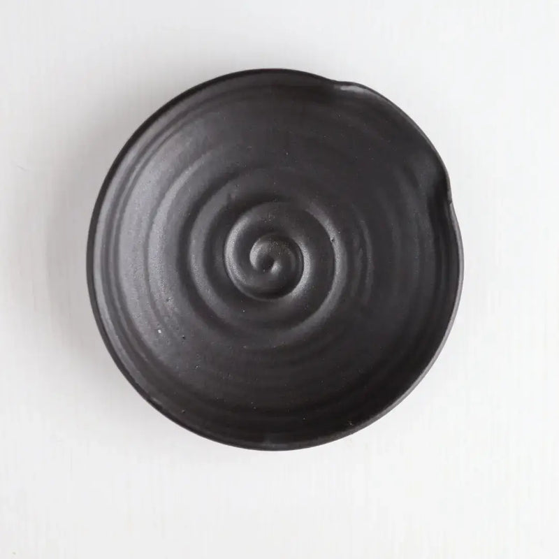 Gravesco Pottery - Handmade Pottery Spoon Rest in Black, viewed from above, features concentric spiral ridges, perfect for holding cooking utensils. Dishwasher safe, 5.5 diameter.