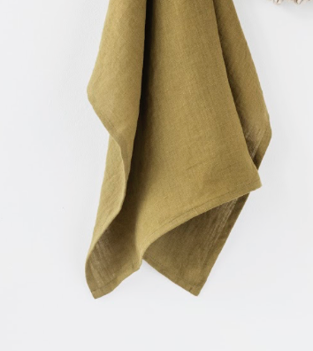 Close-up of a MagicLinen ruffle trim tea towel, showcasing its soft, absorbent linen texture. Ideal for kitchen use, enhancing both style and practicality.