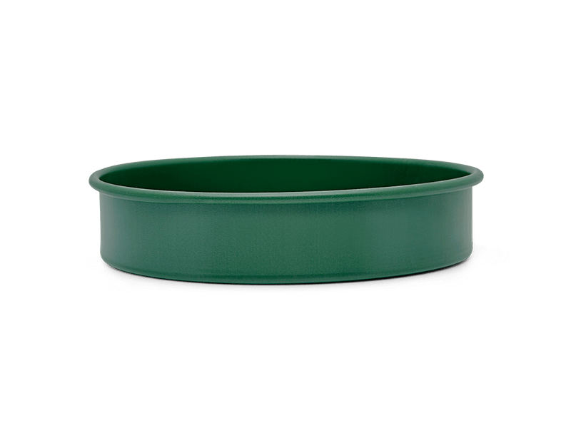 Great Jones | Patty Cake - Broccoli, featuring a wavy, corrugated bottom for easy release, crafted from nonstick ceramic for even baking. Oven and dishwasher safe.