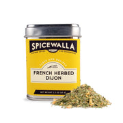 Spicewalla | French Herbed Dijon spice container alongside dried herbs, featuring a yellow and black label, ideal for enhancing various dishes with elegant flavor.