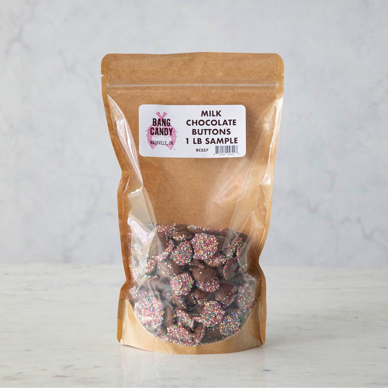 Hester & Cook | Milk Chocolate Buttons - Sample Bag: A resealable kraft bag with window showing milk chocolate nonpareils, topped with multicolored sprinkles, perfect for sweet displays.