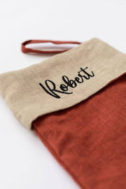 MagicLinen - Embroidered Christmas Stocking in red clay and natural linen, personalized with Roberti, featuring a hanging loop, crafted from soft linen for a festive touch.
