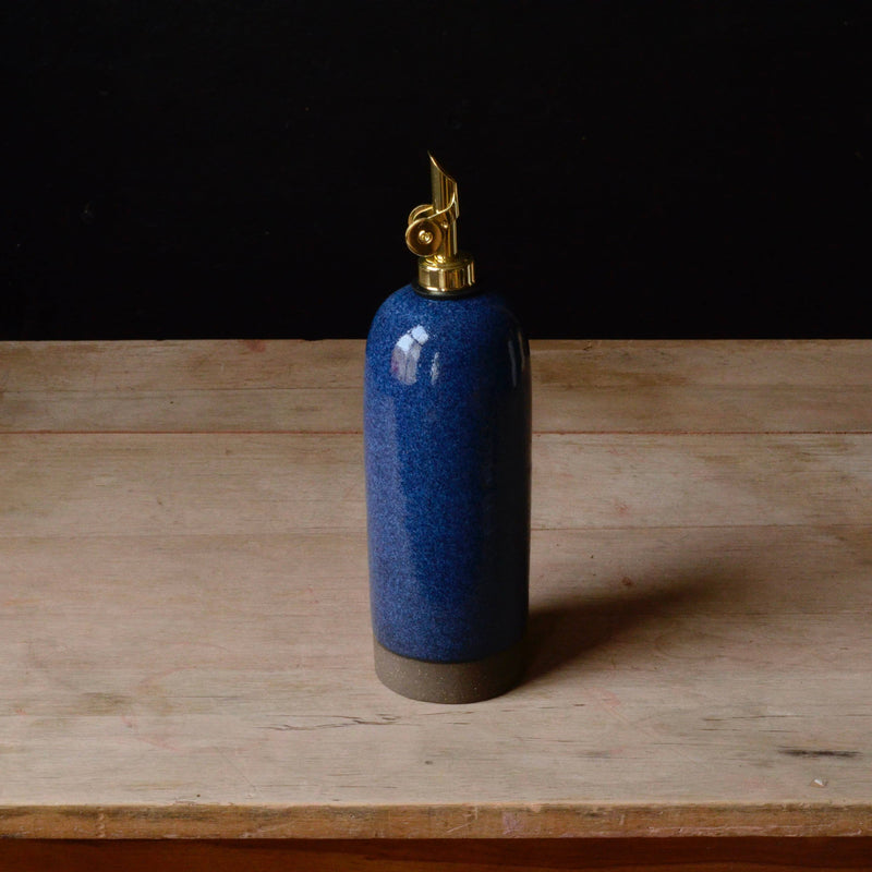 Rose Line Pottery - Oil Bottle - Denim Blue - 22 Ounces, handcrafted ceramic with gold-plated spout, ideal for oils and syrups, displayed on a wooden surface.