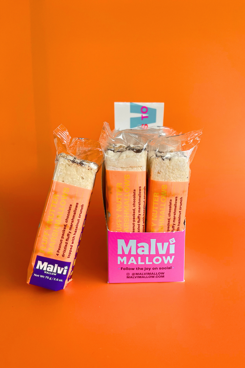 Malvi Mallow - Fluffy Nutter 4-Pack Marshmallows in a pink display box, showcasing individually wrapped bars with nutty toppings, perfect for gourmet snacking or enhancing desserts.