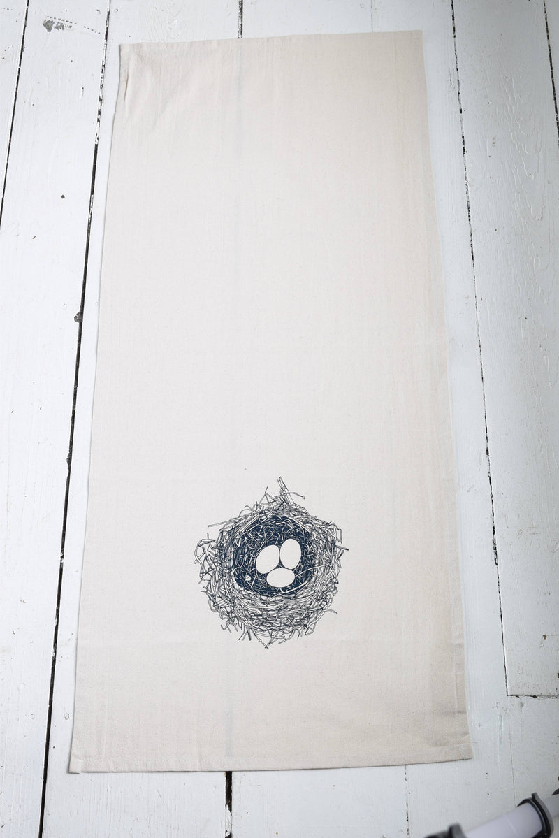Hearth and Harrow - Nest Tea Towel: A large organic cotton towel with a dark blue bird's nest design, perfect for kitchen or dining use.