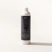 Made In | Ceramic Cleaner in a tall white squeeze-bottle, ideal for polishing cookware, removing stains and residue from bakeware and enameled cast iron.