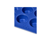 Great Jones | Stud Muffin - Blueberry: Nonstick muffin pan for 12 muffins, featuring even heat distribution and easy cleanup, shown in close-up.