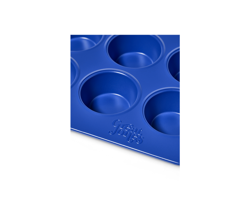Great Jones | Stud Muffin - Blueberry: Nonstick muffin pan for 12 muffins, featuring even heat distribution and easy cleanup, shown in close-up.