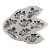 Nordic Ware | Dinosaur Cakelet Pan: Metal mold with dinosaur shapes for baking 8 muffins or cakes, featuring nonstick cast aluminum for easy release.